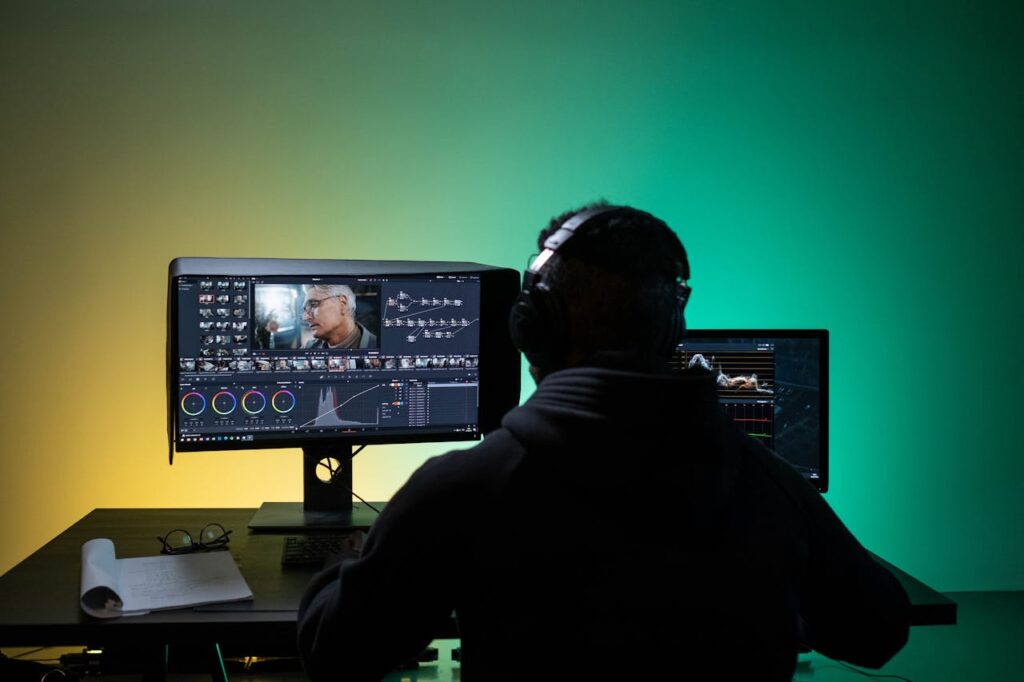 zipwp-image-8102677 A Man Sitting on Front of the Computer while Editing Video